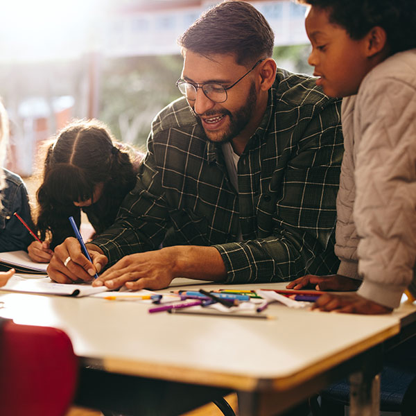 Teacher helping children