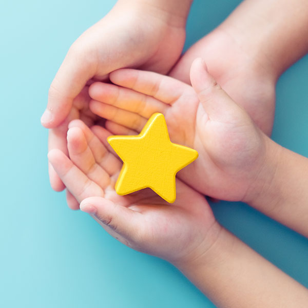 Child holding wooden star